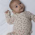 petit piao beige overslagromper met roze bloemetjes